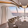 The private dining space, Privee, onboard Ocean Vista is designed to make guests feel like they are dining inside a flower, with the backlit, debossed walls and the chandelier resembling the petals and the pistils, respectively (Photo: Nick Tortajada
