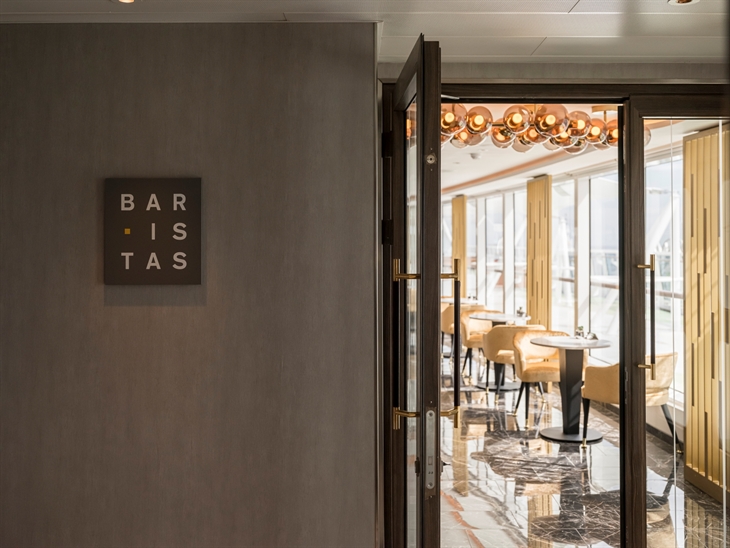 Tillberg Design of Sweden used crème and black polished marble, antique mirrors and glass chandeliers in the ship’s Barista room