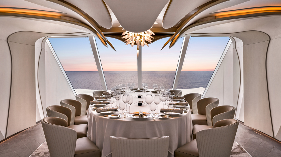 The private dining space, Privee, onboard Ocean Vista is designed to make guests feel like they are dining inside a flower, with the backlit, debossed walls and the chandelier resembling the petals and the pistils, respectively (Photo: Nick Tortajada