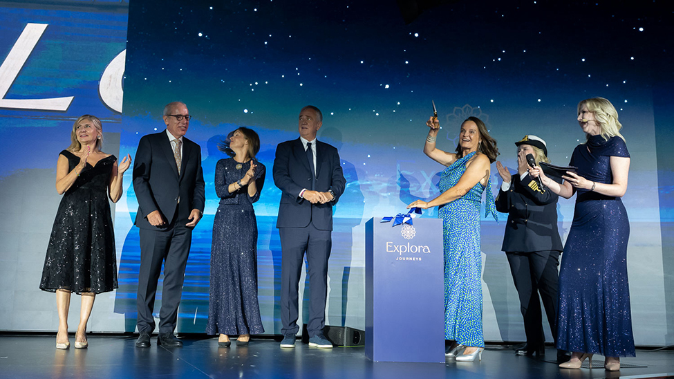  Cristina Ozores, marine conservationist, dive trainer and National Geographic educator, cuts the ribbon to break the bottle of champagne over Explora III’s hull during the christening ceremony (Photo: Explora Journeys) 