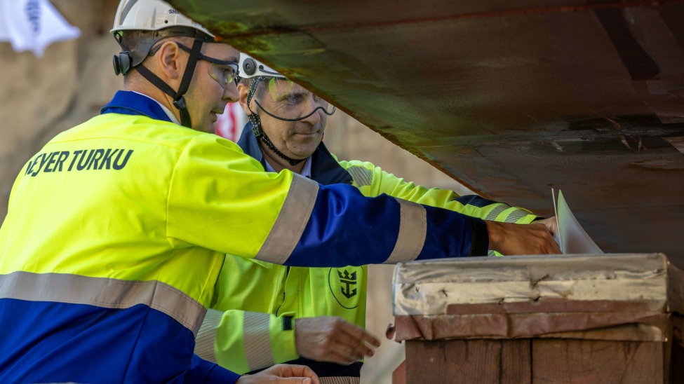 Project managers Saku Jaatinen at Meyer Turku and Janne Auvinen at Royal Caribbean Group, placed coins under the keel for the ceremony (Photo: Royal Caribbean Group)